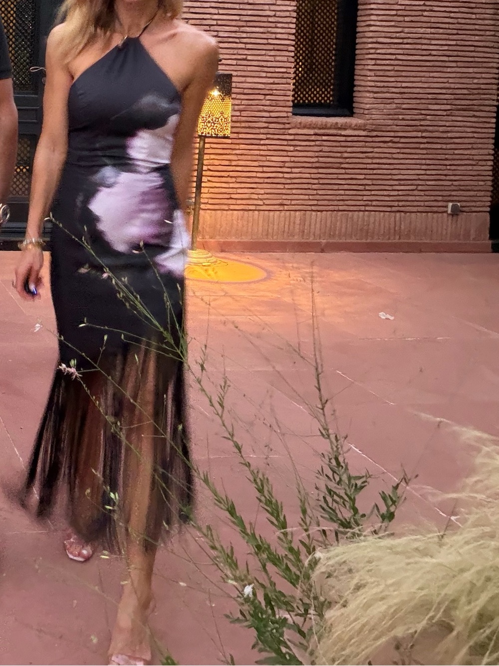 One-Shoulder Black Dress with Pink Floral Accent and Fringe